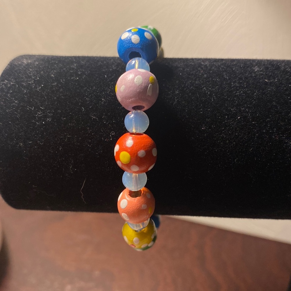 Bright colored Happy polka-dotted wood beads, interspersed w/tiny clear beads